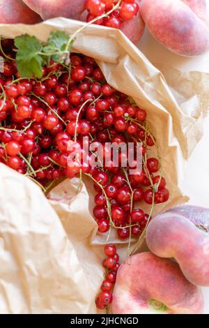 Draufsicht auf rote Johannisbeerbeeren in Papiertüte. Sommer gesunde Ernte Nahrung Stockfoto