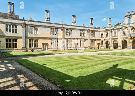 Gut gepflegter Garten im Innenhof eines verfallenen und ruinierten englischen elisabethanischen Herrenhauses, England. Stockfoto