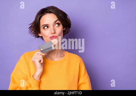 Porträt von attraktiv gesinnten neugierigen Mädchen in der Bank-Karte entscheiden, Kopie Raum isoliert über violett lila Farbe Hintergrund Stockfoto