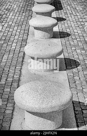 Eine vertikale Aufnahme von Betonsitzen auf einem gepflasterten Weg in Helsingor, Dänemark Stockfoto