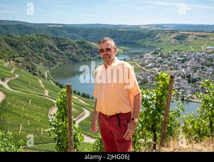 PRODUKTION - 12. Juli 2022, Rheinland-Pfalz, Piesport: Günther Klum steht hoch über der Mosel vor seinem steilen Weinberg Güntherslay. Seit fast zehn Jahren ist Klum im Besitz des Weinbergs. Foto: Harald Tittel/dpa/dpa-mag Stockfoto