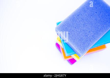 Draufsicht auf Schwämme zum Abwaschen, auf weißem Hintergrund, isoliert. Bunt bunt bunt, wie Regenbogenschwämme einander legen. Stockfoto