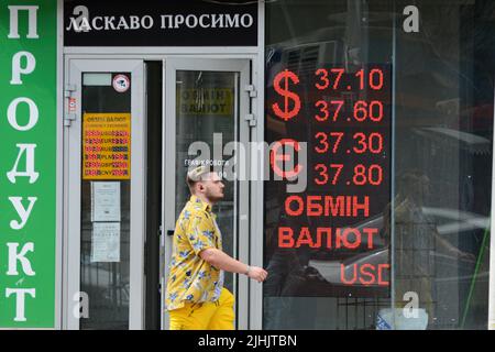 Kiew, Ukraine. 18.. Juli 2022. Ein Mann geht in der Nähe eines Schildes, das den Wechselkurs der ukrainischen Griwna gegen die Fremdwährung in Kiew anzeigt. Der US-Dollar ist in der vergangenen Woche stark gestiegen, aber mehr als vier Monate nach der russischen Invasion in die Ukraine kämpfen Politiker in Kiew darum, den Haushalt am Laufen zu halten, während das Militär des Landes gegen die russische Invasion kämpft. (Foto: Aleksandr Gusev/SOPA Images/Sipa USA) Quelle: SIPA USA/Alamy Live News Stockfoto