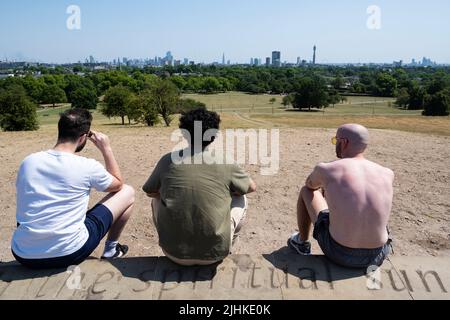 London, Großbritannien. 19. Juli 2022. Wetter in Großbritannien – die Männer genießen die Aussicht auf Primrose Hill während der schweren Hitzewelle, die einen Großteil des Landes in sich aufhält, wo die Temperaturen heute zum ersten Mal über 40C Grad überschritten haben. Die britische Gesundheitsbehörde (UKHSA) hat eine Gesundheitswarnung der Stufe 4, einen „nationalen Notfall“, herausgegeben, und das Met Office hat seine erste rote Warnung ausgegeben. Kredit: Stephen Chung / Alamy Live Nachrichten Stockfoto