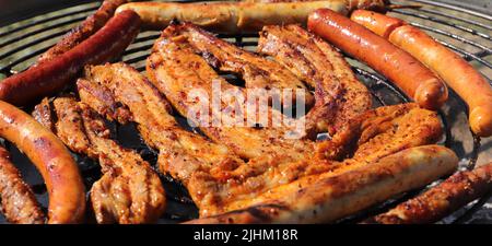 Verschiedene Fleisch- und Wurstwaren auf dem Holzkohlegrill Stockfoto