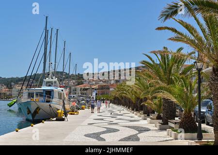 Argostili, Kefalonia, Griechenland - Juni 2022: Menschen, die an der Promenade vor dem Hafen in Argostili spazieren Stockfoto