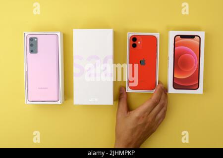 Tjumen, Russland-18. Juli 2022: Neues Apple iPhone 12 Mini Produkt rotes Smartphone und neues Samsung S20 FE Handy, Fan Edition Stockfoto