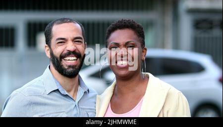 Verheiratet interracial Paar lachen und lächeln. Afrikanische Frau und hispanischer Mann mit gemischter Rasse. Die Menschen im echten Leben lachen und lächeln Stockfoto