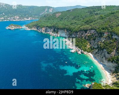 Luftaufnahme des Kolias Strandes auf der Insel Korfu. Griechenland. Klippen mit Blick auf den Strand und ein unberührtes grünes und blaues Meer. Festfahrte Boote Stockfoto