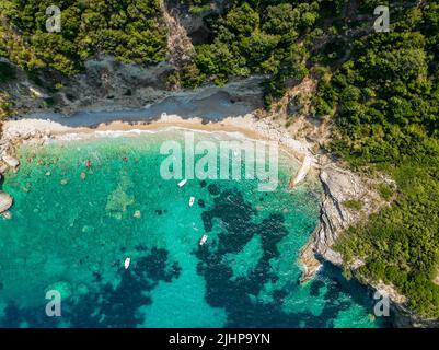 Luftaufnahme des Kolias Strandes auf der Insel Korfu. Griechenland. Klippen mit Blick auf den Strand und ein unberührtes grünes und blaues Meer. Festfahrte Boote Stockfoto