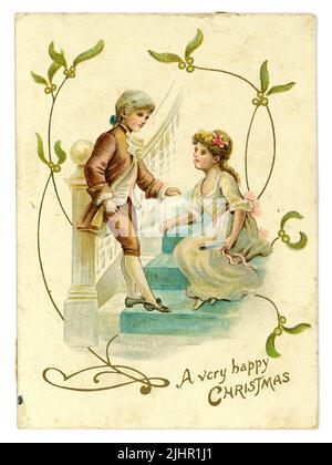 Original Edwardian Ära Weihnachtsgruß-Karte, Mistel, Kinder im Regency-Stil (Regency war 1811-1820) Kleidung Kinderpaar umwerben, ca. 1905 Großbritannien Stockfoto