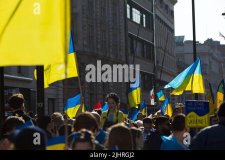 Die Menschen versammeln sich und marschieren während des marsches ‘London steht mit der Ukraine’, um Solidarität mit der Ukraine im Zentrum Londons zu zeigen. Stockfoto