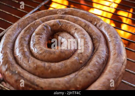 Boerewors Wurst auf einem Braai. Boerewors oder Braai wors, ein traditionelles südafrikanisches Wurstfleisch, das normalerweise auf einem Braai oder grill zubereitet wird. Grillfleisch Stockfoto