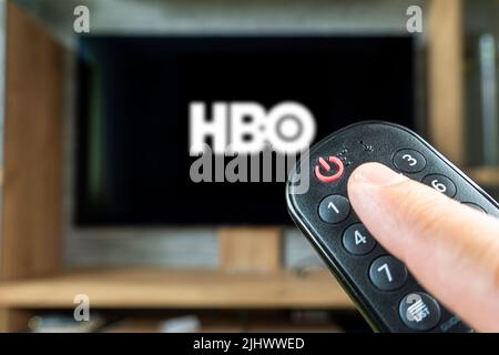 Barnaul. Russland 20. Juni 2022: Fernbedienung in der Hand und das Logo des US-Senders HBO auf dem Fernsehbildschirm Stockfoto