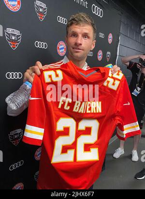 Washington, USA. 20.. Juli 2022. Fußball: US-Reise des Fußball-Bundesligisten FC Bayern München. Thomas Müller hält nach dem Testspiel gegen Washington, DC United ein Trikot mit dem Aufdruck „FC Bayern“ des NFL-Teams Kansas City Chiefs. (Zu 'so geht es ohne Lewandowski: Mané und de Ligt Punkten in Bayerns 6:2') Quelle: dpa/Alamy Live News Stockfoto