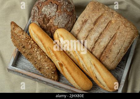 Sauerteig Brot in einem rustikalen Tablett, handgefertigt gerade gebacken - Stock Foto Stockfoto