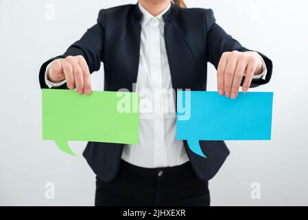 Geschäftsfrau Hält Zwei Sprechblasen Mit Wichtigen Botschaften. Frau Präsentiert Krutiale Informationen Auf Verschiedenen Dialogballons. Lady Showing Stockfoto