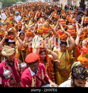 Neu Delhi, Indien April 03 2022 - Frauen mit Kalash am Kopf während des Jagannath-Tempels Mangal Kalash Yatra tragen indische Hindu-Anhänger irdische Töpfe Conta Stockfoto