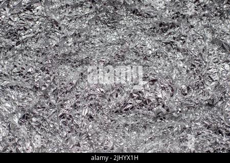 Zerknitterte Aluminiumfolie flacher Hintergrund und Textur. Stockfoto