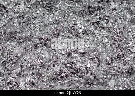 Zerknitterte Aluminiumfolie flacher Hintergrund und Textur. Stockfoto