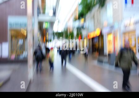 Verschwommene Bewegung von Menschen, die in einer Stadt außerhalb reisen. Defokussiert auf die Menschenmenge von Touristen, Reisenden und Fußgängern, die im Ausland unterwegs sind Stockfoto