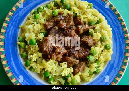 Rindfleisch Korma serviert auf einem bunten Teller Stockfoto