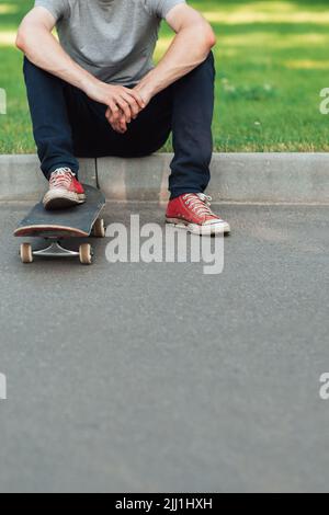 Unverkennbarer Hipster-Mann mit Skateboard Stockfoto