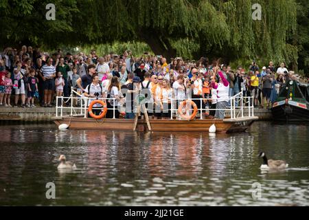 Stratford-upon-Avon, Großbritannien. 22.. Juli 2022. Ein Baton-Träger trägt das Baton der Commonwealth Games Queen an Bord einer Fähre, die den Fluss Avon in Stratford-upon-Avon Warwickshire überquert.Quelle: Chris Radburn/Alamy Live News Stockfoto