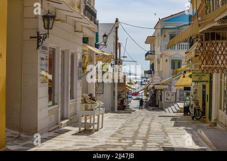 Stadtansicht der Tinos Insel mit engen Kopfsteinpflasterstraßen und Souvenirläden, die lokale Produkte, Souvenirs, Tinos, Kykladen, Ägäisches Meer, Griechenland verkaufen Stockfoto