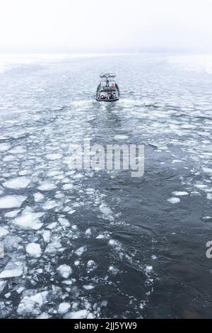 Eisbrecher-Boot, das durch das Eis schwimmt, im Fluss Havel Stockfoto