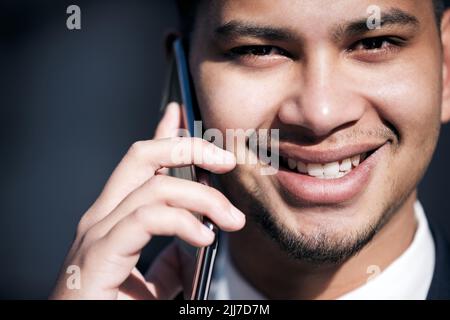 Ich versiegele den Deal jetzt am Telefon. Porträt eines jungen Geschäftsmannes, der in der Stadt unterwegs auf einem Mobiltelefon spricht. Stockfoto