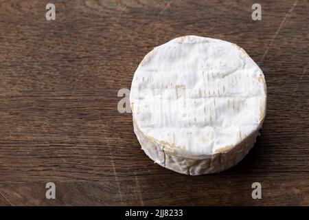 Brie-Käsesorte. Camembert-Käse. Frischer Brie-Käse. Französischer Käse auf einem Holztisch. Stockfoto