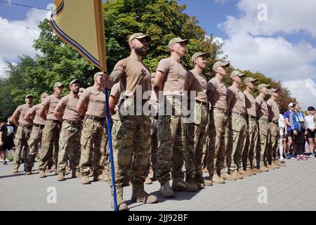 Mitglieder des Asow-Regiments werden während des laufenden Flashmob „Run for Asovstal“ in Zaporizhzhya auf einer Parade gesehen. Die Organisatoren der Veranstaltung sind die Vereinigung der Familien der Verteidiger von Asovstal. Ziel des Marathons war es, die Welt an den Heldentum der ukrainischen Verteidiger von Mariupol während der russischen Aggression gegen die Ukraine zu erinnern. Das Asov-Regiment ist eine Einheit der Nationalgarde der Ukraine, die sich früher in Mariupol befand. Stockfoto