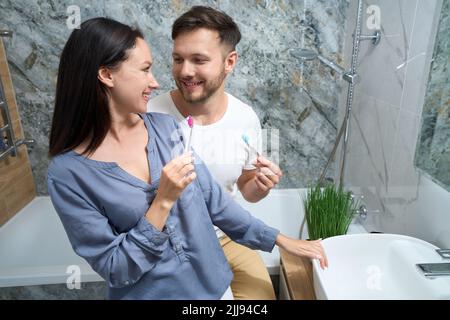 Lustige morgendliche Routine mit Zahnbürsten im Badezimmer Stockfoto