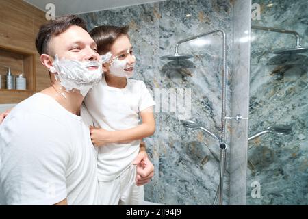 Das Rasieren macht Papa und kleinen Sohn Spaß Stockfoto