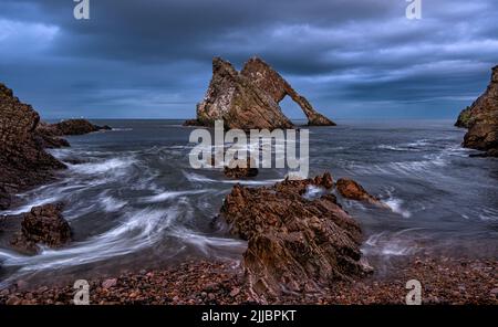 Bow Fiddle Rock ist ein natürlicher Meeresbogen in der Nähe von Portknockie an der schottischen Moray-Küste Stockfoto