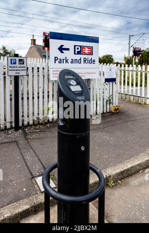 Nahaufnahme eines BP Pulse 7, einer Ladestation für zwei Elektrofahrzeuge an einer Scotrail-Bahnstation, mit einem Park and Ride-Schild im Hintergrund Stockfoto