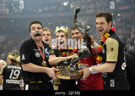 ARCHIVFOTO: Marke Heiner feiert am 26. Juli 2022 seinen 70.. Geburtstag, pure Begeisterung mit (von links) Trainer Heiner BRAND und den Spielern Michael KRAUS, Torwart Henning FRITZ und Markus BAUR mit der WM-Trophäe, der WM, Pokalen; Endspiel Endspiel Deutschland (GER)-Polen (POL) 29:24, am 4.. Februar 2007 in Köln, Weltmeister Deutschland Handball-Weltmeisterschaft 2007 in Deutschland, vom 19.. - 04.02.2007. Januar ?Sven Simon # Princess-Luise-Str. 41 # 45479 M uelheim/R uhr # Tel 0208/9413250 # Fax. 0208/9413260 # Konto 244 293 433 # P ostbank Essen # BLZ 360 100 43 # Stockfoto