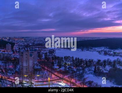 Sonnenuntergang am Stadtrand von Kiew und verschneite Wälder im Winter. Kiew, Ukraine Stockfoto