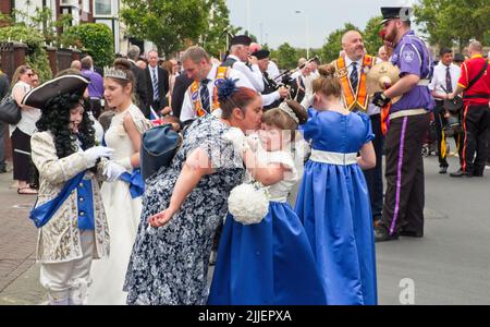 Mutter und Tochter umarmen sich vor der Parade am Orangen Tag !2.. Juli Stockfoto