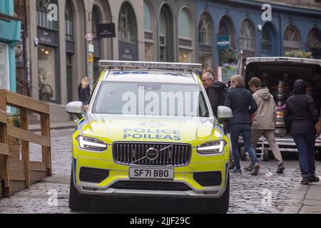 Schottische Polizeipoileas in einem Volvo Polizeiauto auf den Kopfsteinpflasterstraßen West Bow, Edinburgh Altstadt, Sommer 2022, Schottland, Großbritannien Stockfoto