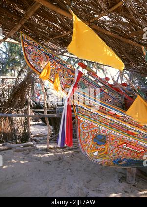 Thailand: Korlae Fischerboote, Saiburi, Südthailand. Entlang der Ostküste der Halbinsel Thailand, von Ko Samui nach Süden, werden seit Hunderten von Jahren farbenfrohe, bemalte Fischerboote von muslimischen Fischern gebaut und dekoriert. Die besten Beispiele für diese mittlerweile rückläufige Industrie stammen aus den Werften des Bezirks Saiburi, Provinz Pattani. Zu den Figuren, die auf den detailreichen Rumpfdesigns abgebildet sind, gehören der singha-Löwe, der gehörnte Vogel Gagasura, die Payanak-Seeschlange und der garuda-Vogel, der sowohl das Symbol des thailändischen Königreichs als auch der mythische Berg des Hindu-Gottes Vishnu ist.
