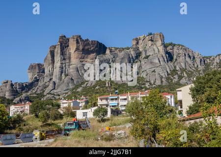 Die natürlichen Höhlen für Mönche in den Felsformationen von Meteora über den griechischen weißen Häusern von Kastraki, Kalabaka, Griechenland Stockfoto