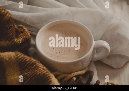 Tasse Latte in einem gemütlichen und bequemen Bett Stockfoto