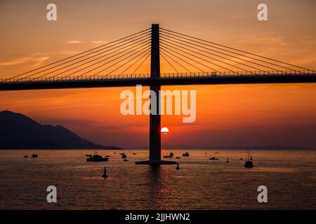 Die Sonne untergeht über der Peljesac-Brücke während der Eröffnungsfeier der Peljesac-Brücke am 26. Juli 2022 in Komarna, Kroatien. Foto: Zvonimir Barisin/PIXSELL Stockfoto