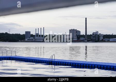 Kiel, Deutschland. 27.. Juli 2022. Dunkle Wolken ziehen bei Sonnenaufgang über das Küstenkraftwerk (l) und das alte Kohlekraftwerk an der Kieler Förde. Quelle: Frank Molter/dpa/Alamy Live News Stockfoto