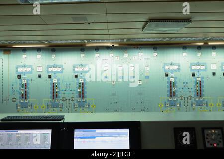 Armaturenbrett im Schiffsmaschinenraum mit vielen Böden, Anzeigen, kleinen Anzeigelampen und Schaltplänen von Motoren und Generatoren, Voltmetern, Amperemeten Stockfoto