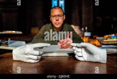 Der Künstler Peter Walker, mit einer kleineren Version seines Werks, Connection, einer zeitgenössischen Variante von Michelangelos Meisterwerk, der Schöpfung von Adam, vor der Eröffnung seiner Ausstellung „being Human“ in der Liverpool Cathedral. Bilddatum: Dienstag, 26. Juli 2022. Stockfoto