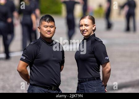 Die Polizei in Schottland startet eine Rekrutierungskampagne mit den neuen Offizieren Steve Chan und Natalie Barrie, da mehr als 300 neue Offiziere während einer Zeremonie im Police Scotland Headquarters, Tulliallan, Perthshire, ihren Amtseid ablegen. Bilddatum: Mittwoch, 27. Juli 2022. Stockfoto