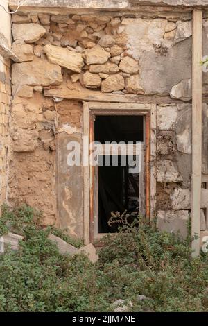Die vertikale Aufnahme eines alten Gebäudefensters Stockfoto